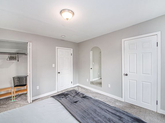 Full-length mirror and full closet with hangers and laundry hamper