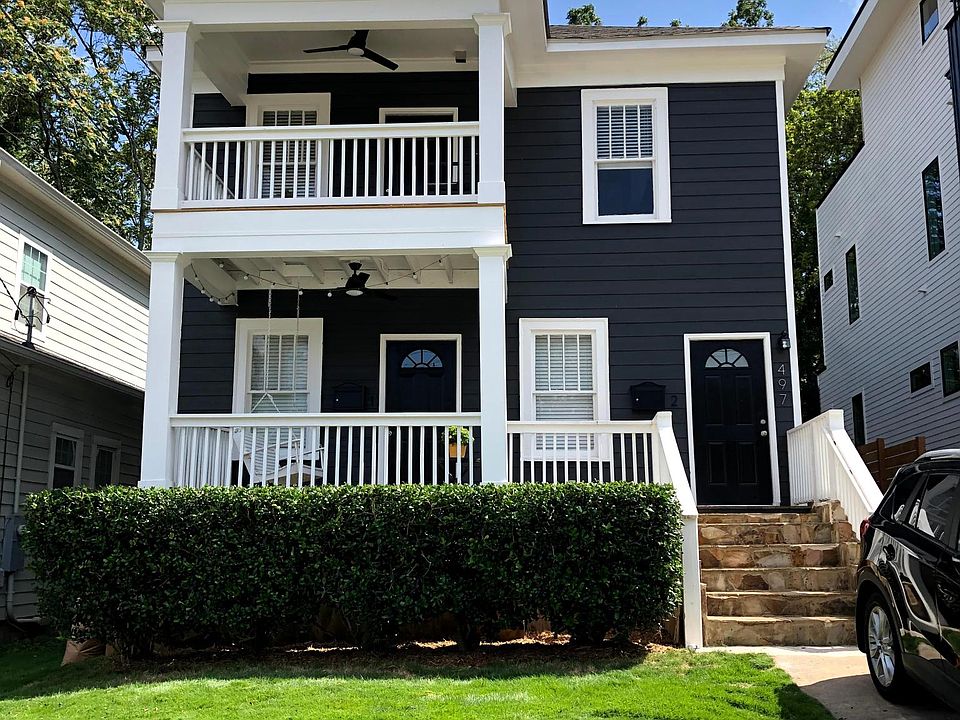 Front of duplex. New covered porches with ceiling lights, fans, and electrical outlets. Small front yard with one first come first serve off-street parking space.