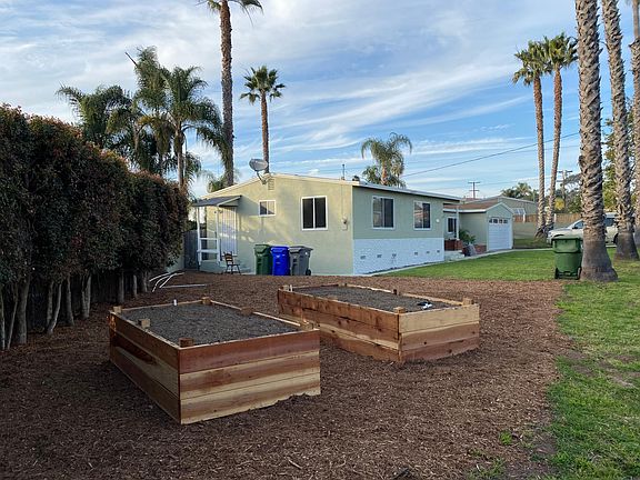 Irrigated garden boxes in side yard ready for planting.