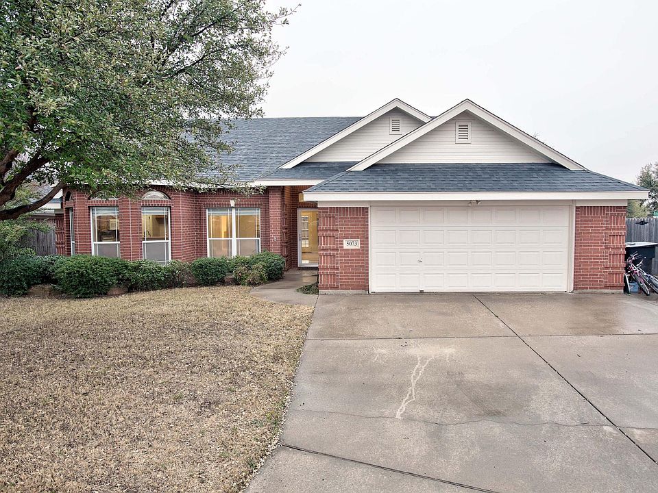 Front view with oversize driveway