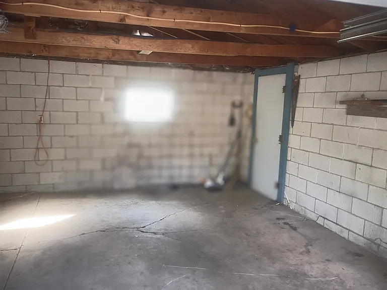 inside two car garage with door going into the backyard