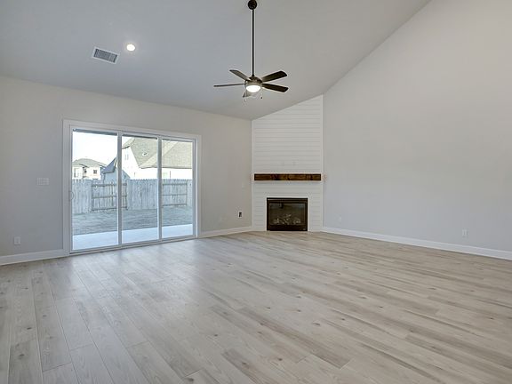 Spacious living room with a fireplace, creating the perfect spot to lounge.