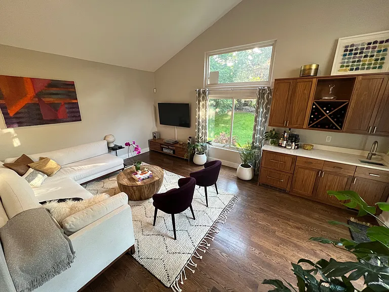 View of the wet bar and TV living room that faces the west side of the yard. You can also access the patio through sliding doors next to the wet bar.