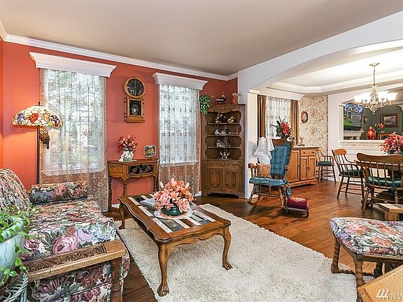 Beautiful crown molding, arched entries and hardwood floors in Living Room and Formal Dining Room.