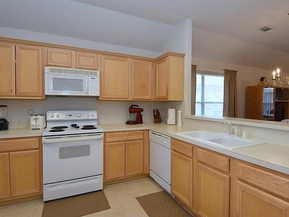Kitchen with lots of cabinets, opens to dining/living combo with large pantry.