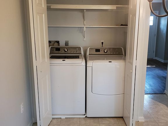 Washer, dryer, and storage. More storage available in the closet under the stairs.