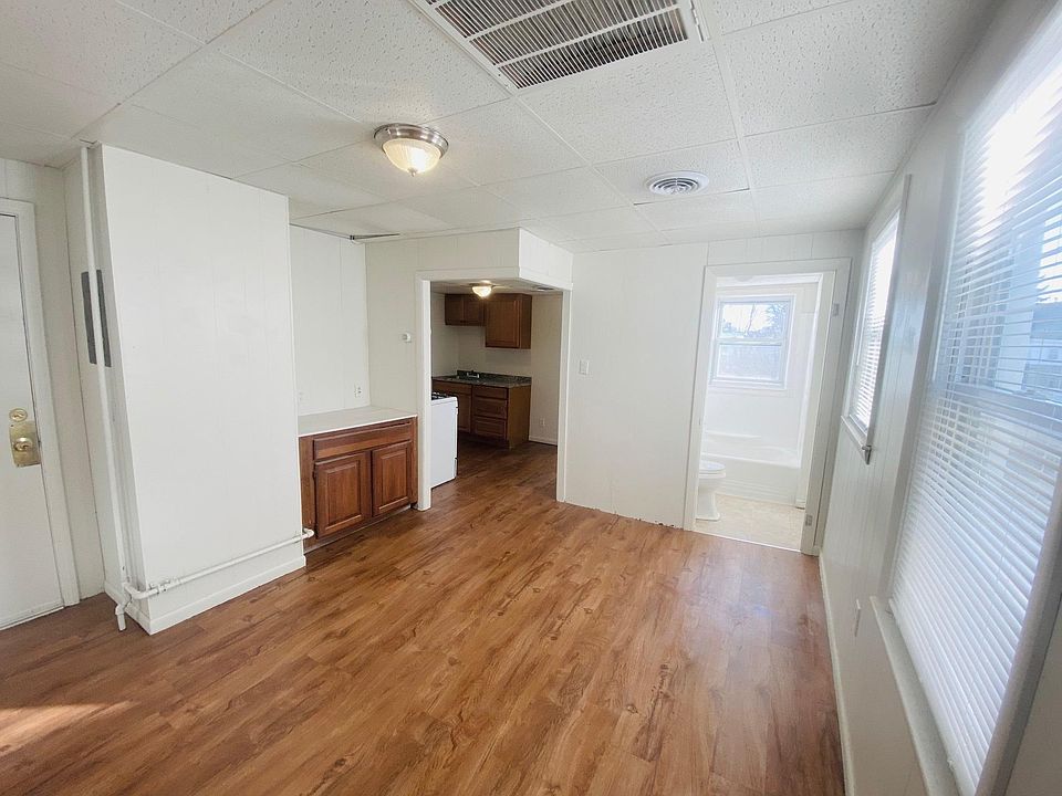 View of living room to kitchen and bathroom. BRAND NEW flooring and paint!