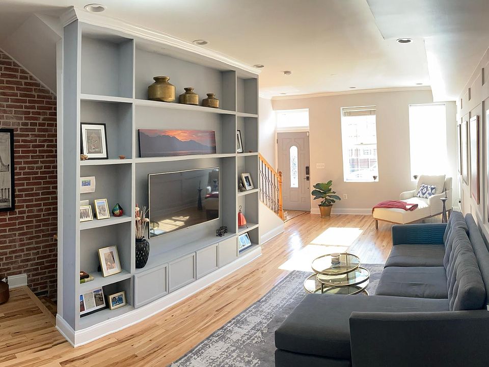 Living/entertaining with built ins, millwork, and natural light galore!