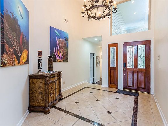 Welcome Your Guests in this Spacious Bright Foyer with Soaring Ceilings and Beautiful Chandelier.