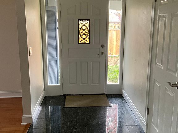 Private fenced entry with tile floors and natural lighting