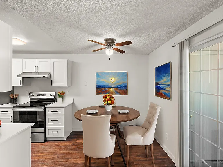 Enjoy stylish dining in this modern kitchen setup with contemporary artwork.