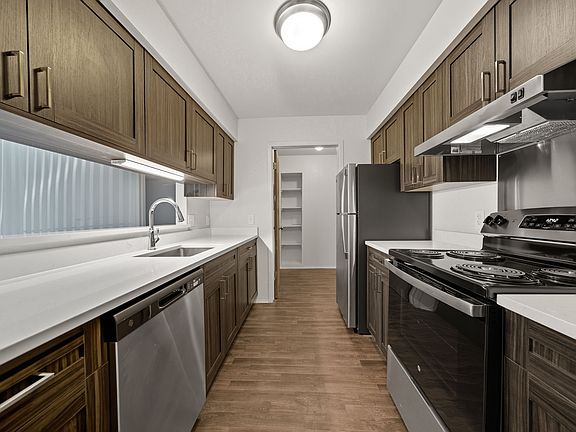 Modern kitchen with stainless steel appliances at Franklin River Apartments in Southfield, MI