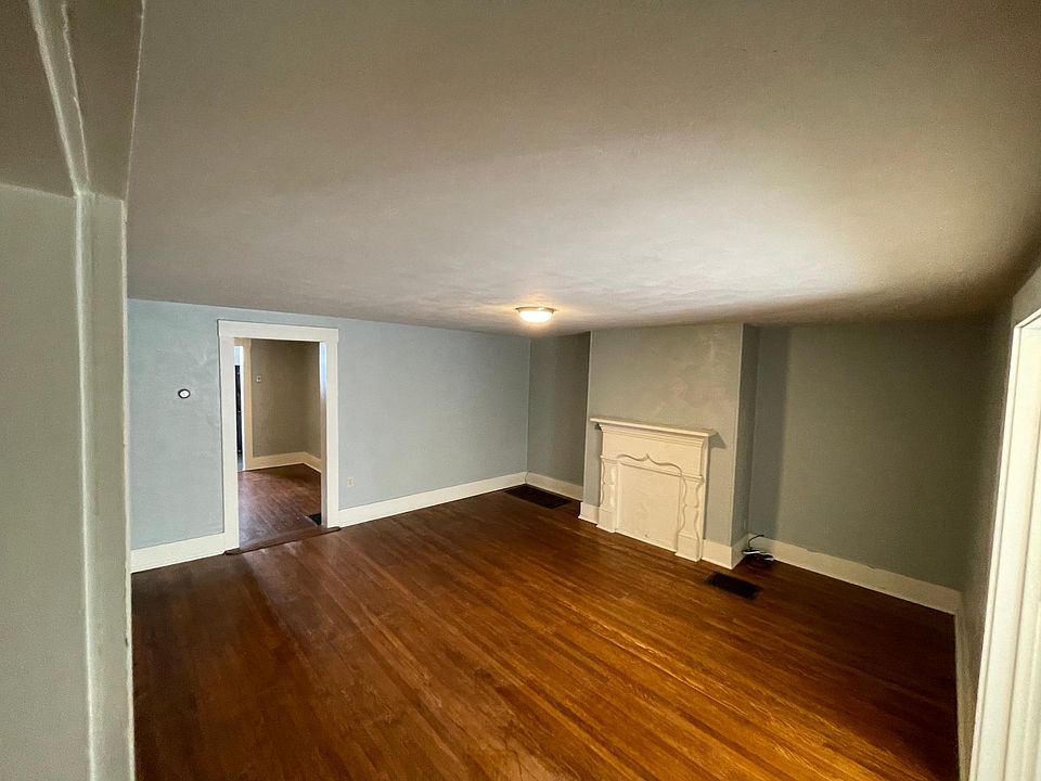 The living room is spacious with hardwood floors.