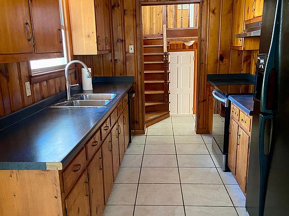Galley kitchen comes equipped with all appliances.