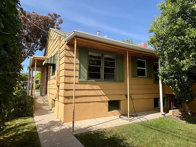 Back of the house, with side door to the kitchen and back door to the basement.