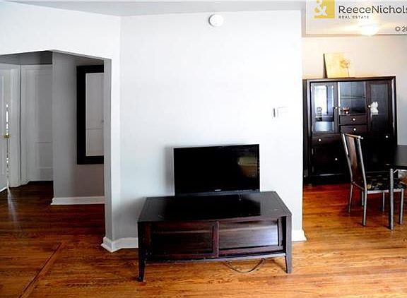 Living room leads to formal dining and two bedrooms