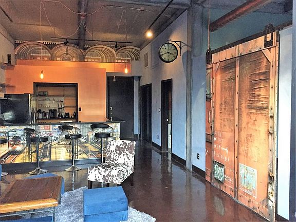 Urban, train station vibe with sliding door to the bedroom.
