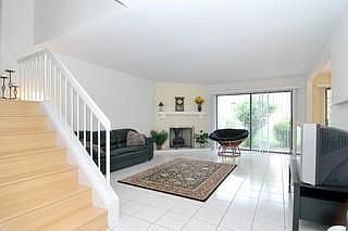 Living room has gas fireplace and sliding doors to back patio.