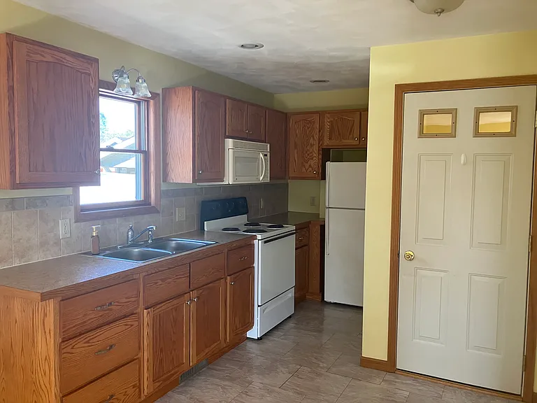 Kitchen includes microwave, refrigerator, oven/stove