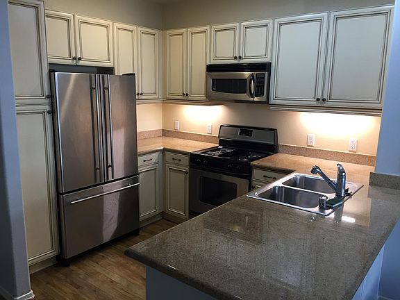 Kitchen, with large refrigerator, microwave, gas range, dishwasher (under the counter) and lots of storage space.