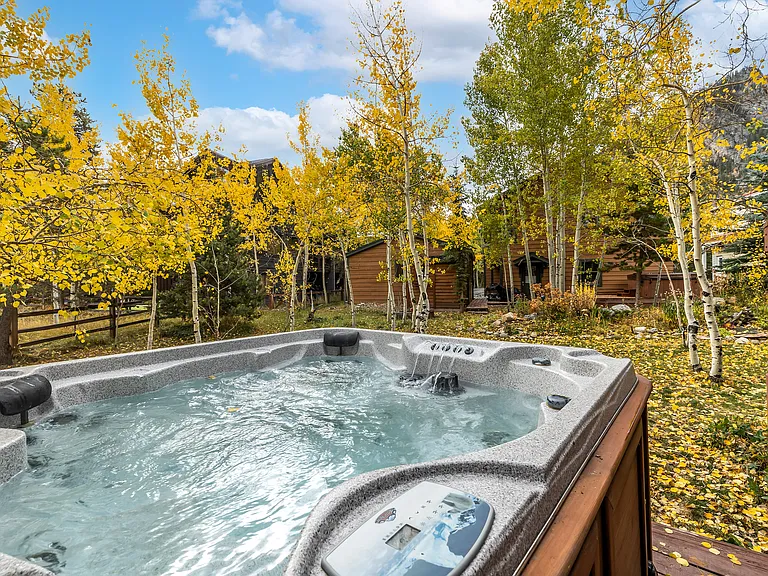 Private hot tub looks toward waterfall and Mount Royal