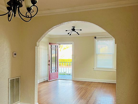 view of living room from dining room with the front door opened