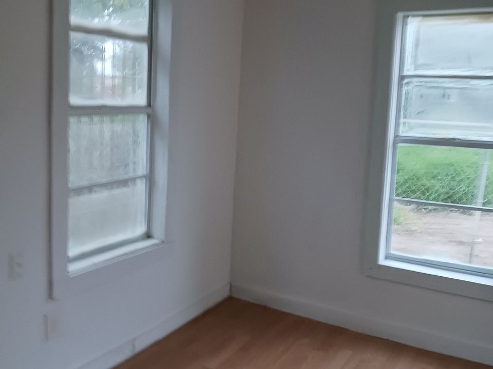freshly renovated Bedroom/living room area with view to side, back and front side of the apartment