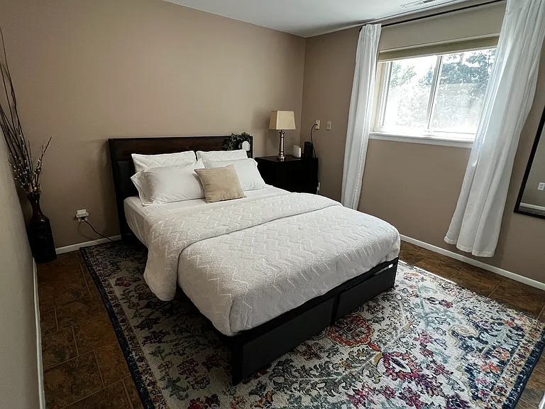 Garden-level bedroom with attached 3/4 bathroom for added privacy and convenience.