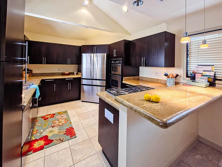 Fully stocked kitchen with full size refrigerator/freezer, oven and gas stove.