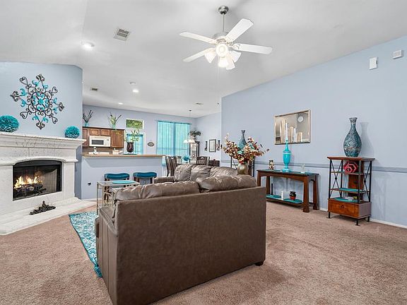 Open and spacious living room area that opens into the kitchen. Lots of room, high vaulted ceilings and a nice gas log fireplace for those winter days.