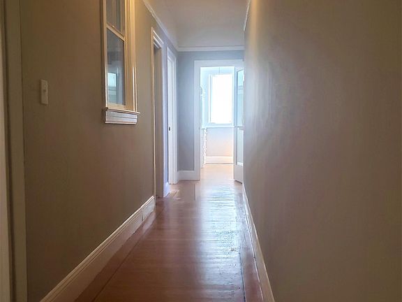 Hallway from front door. Kitchen is left, bathroom next left, bedroom far left. Walk-in closet straight ahead and living room far right.