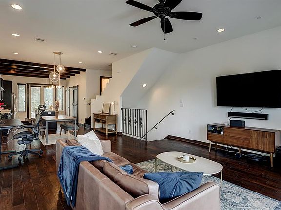 Open concept living with balcony off of kitchen.