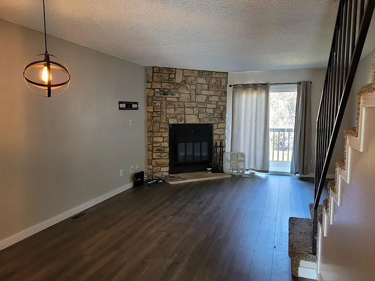 Dining room and living room. Stairs to the right to go upstairs. Access to a large balcony.