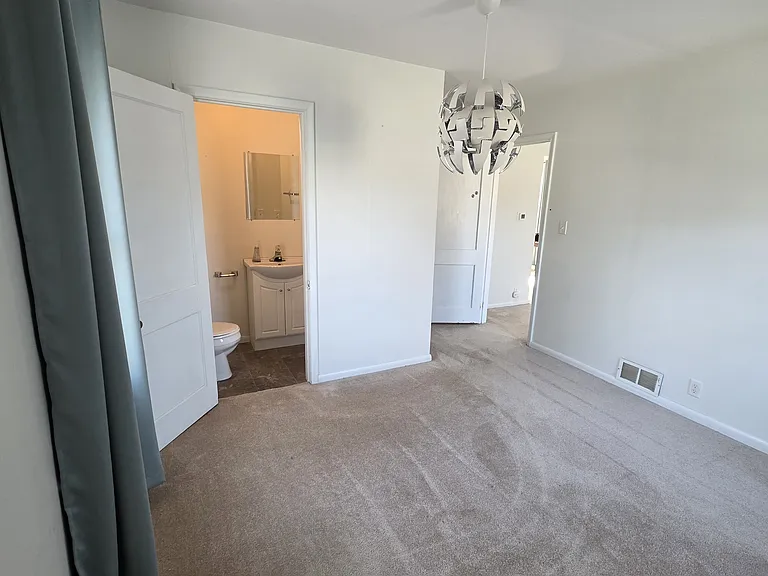 Downstairs bedroom - includes a 0.5 bath ensuite, and small closet.