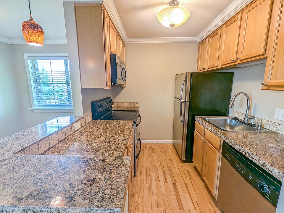 Kitchen and bar are with newer stainless steel appliances and granite countertop