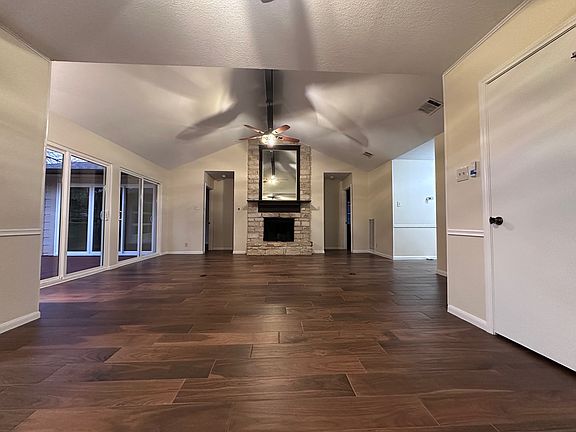 Standing in dining room, flows into living room, bedrooms to left - right of fireplace
