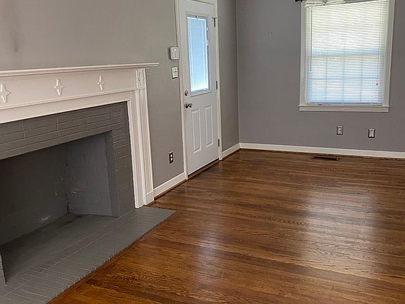 Dining room and non functional fireplace. Hardwood floors.
