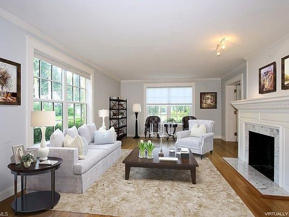 Formal living room virtually staged, original hardwood floors and millwork