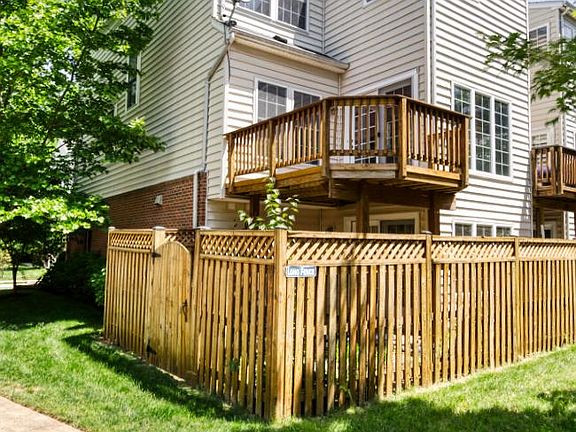 Spacious, sunlit deck! Enclosed backyard with patio and landscaping.