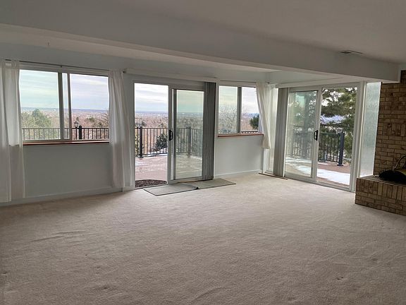 front door entry from the deck with the views to the city of Denver.