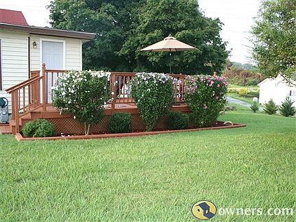 Rear deck w/lots of landscaping
