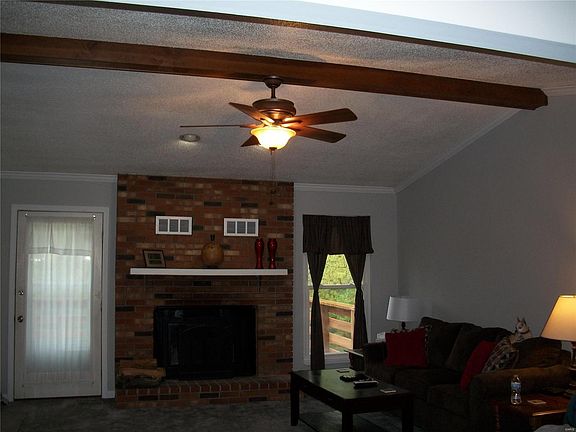 Open vaulted Open vaulted Family Room with wood burning fireplace and ceiling fan