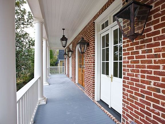 BROAD MAIN FLOOR VERANDA WITH GAS LIGHTS AND 4 SETS OF FRENCH DOORS