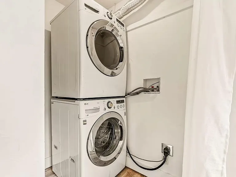 upstairs washer and dryer in primary bedroom