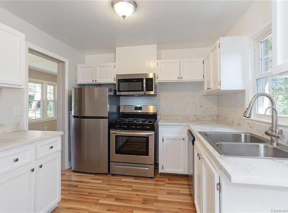 Stylish updated kitchen with concrete counter tops and newer appliances.