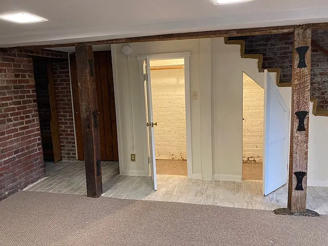 Right wall upon entrance. Staircase to upper floor is closed to tenant. Storage space under staircase and in pantry and broom closet (brown