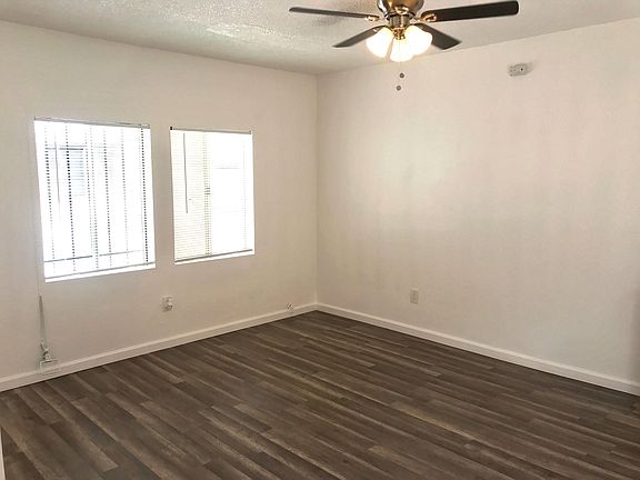 Living room, with new floors, ceiling fan and blinds