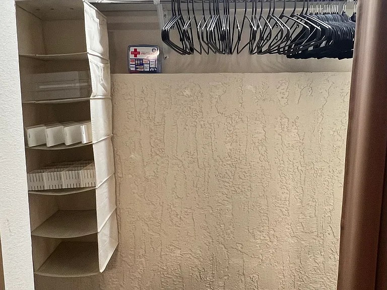 Large walk-in closet provides ample space for luggage and personal belongings.