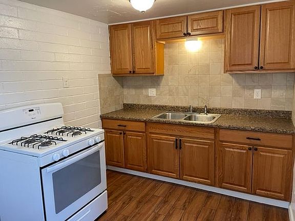 Clean kitchen with gas stove and new refrigerator. Disposal and tile splash and flooring.