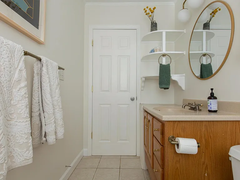 Bathroom view from shower/bath. Extra storage in built in shelves.